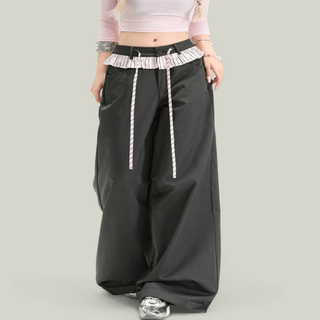 Black wide-leg pants with white drawstrings on a gray background