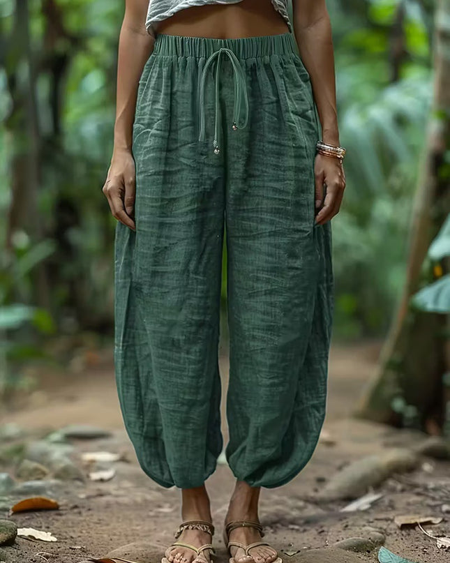 Women wearing green harem pants in a natural setting