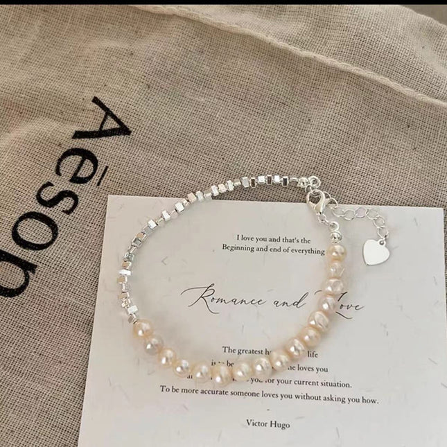 Pearl bracelet on a card with text and 'Aesop' branding in the background