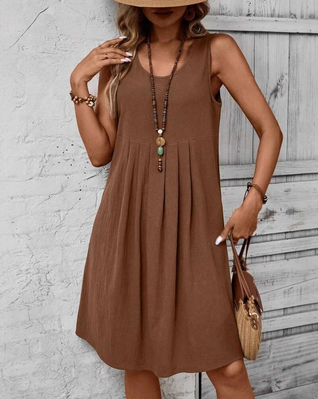 Woman wearing a brown dress with a neutral background