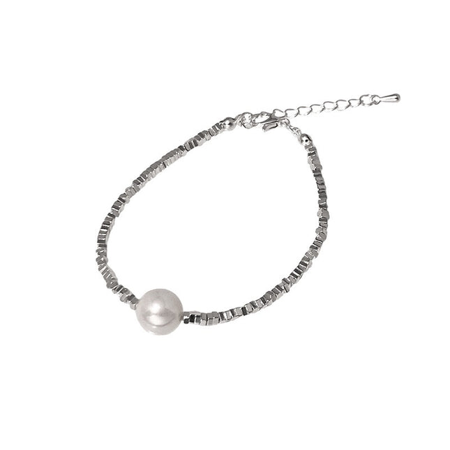 Silver bracelet with a pearl on a white background