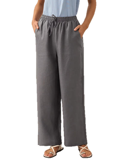 Person wearing gray wide-leg pants on a white background