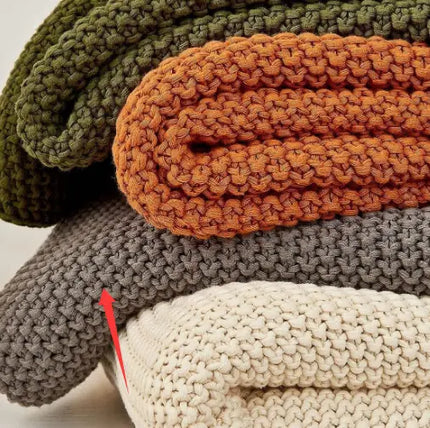 Pile of 4 knitted throw blankets