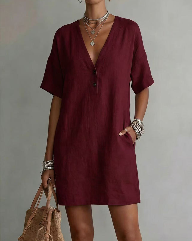 Woman wearing a burgundy dress with a plain background