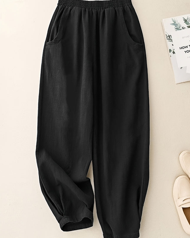 Black wide-leg pants on a light beige background