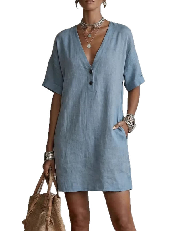 Woman wearing a blue dress with a plain background