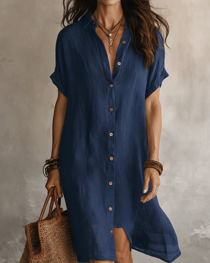 Woman wearing a blue dress holding a woven bag against a neutral background