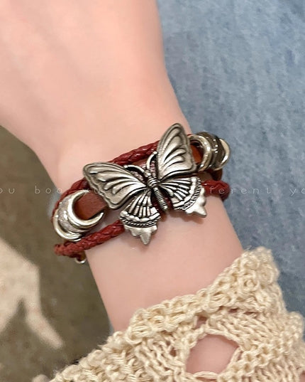 Butterfly bracelet on a wrist with a textured background