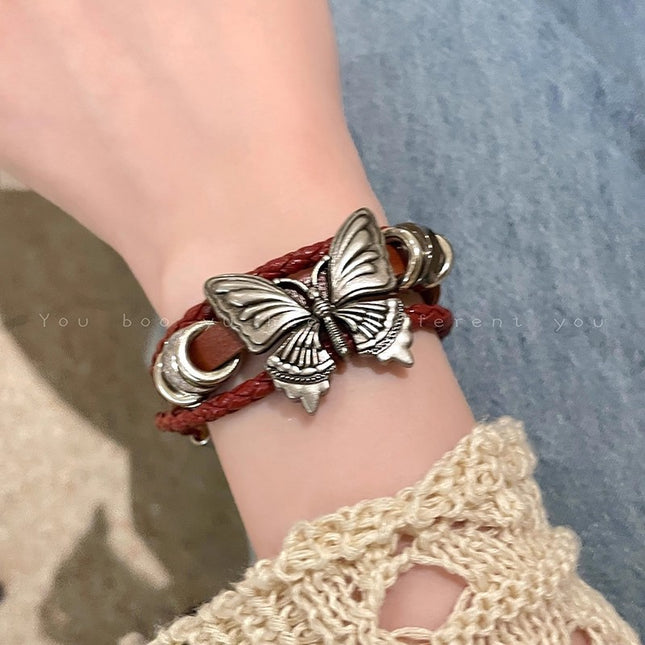 Butterfly bracelet on a wrist with a textured background
