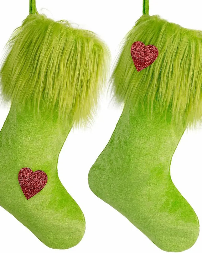 Two lime green Christmas stockings with fluffy faux-fur trim at the top and a small red glitter heart on each stocking, shown on a plain white background.