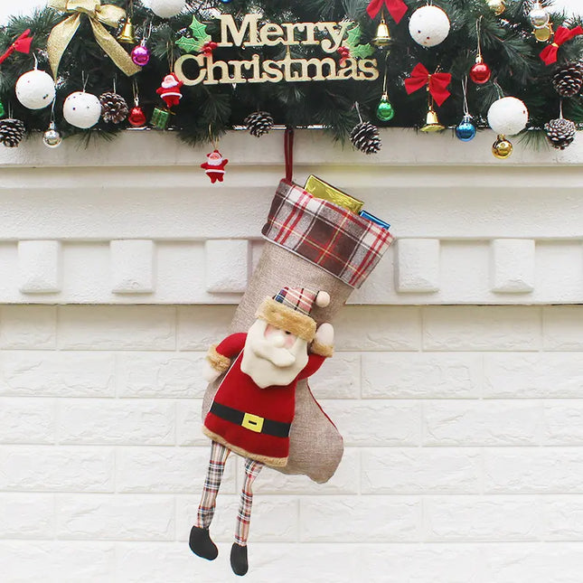 Christmas stocking with Santa Claus design hanging on a fireplace mantle decorated with festive ornaments.