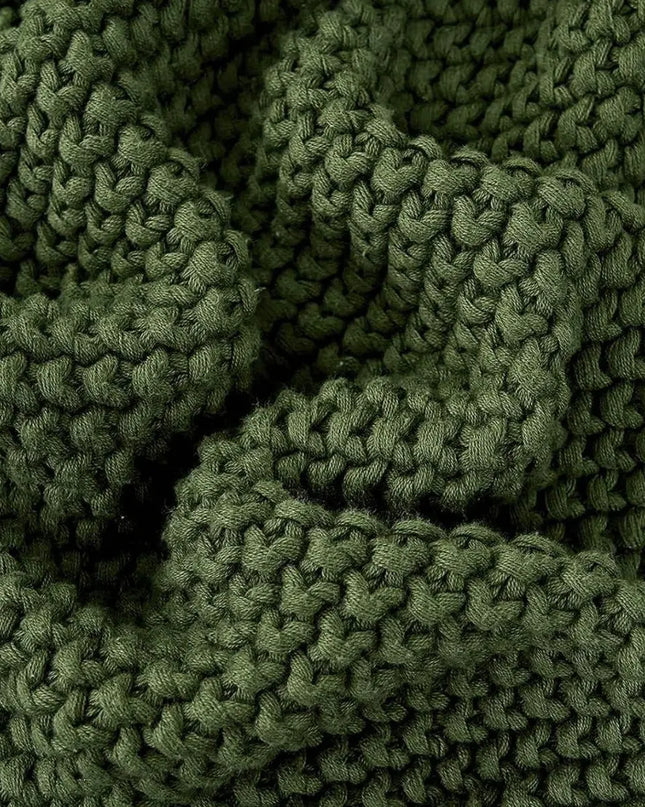 Close up picture of green knitted throw blanket