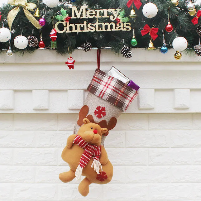 Christmas stocking with reindeer design hanging on a fireplace mantle decorated with festive ornaments.