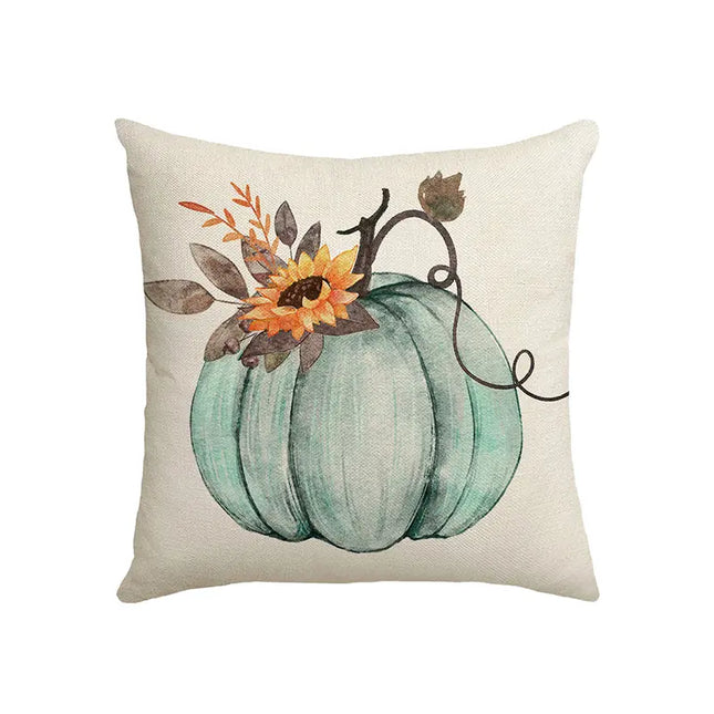Decorative pillow with a teal pumpkin and floral design on a beige background