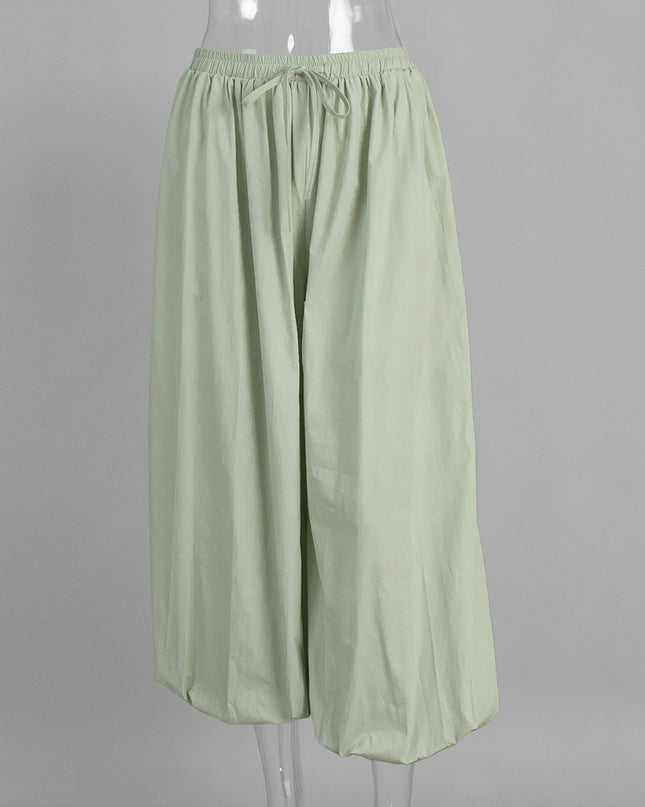Light green wide-leg pants on a mannequin against a gray background