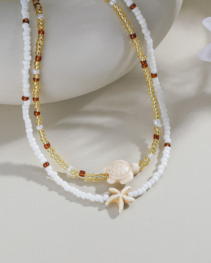 Beaded necklace with starfish charm on a light background
