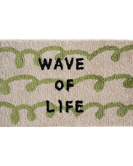 Doormat with 'Wave of Life' text and green leaf patterns on a beige background