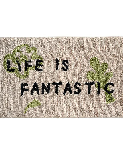 Doormat with 'Life is Fantastic' text and green leaves on a beige background