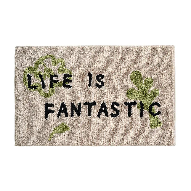 Doormat with 'Life is Fantastic' text and green leaves on a beige background
