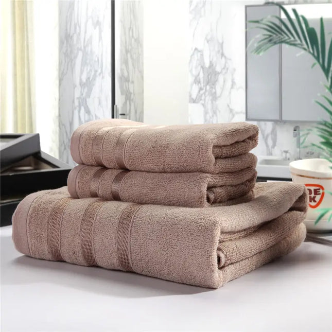 Stack of brown towels on a surface with a blurred indoor background