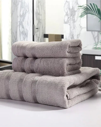 Stack of folded towels on a surface with a blurred indoor background