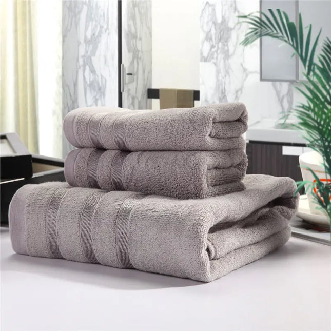 Stack of folded towels on a surface with a blurred indoor background
