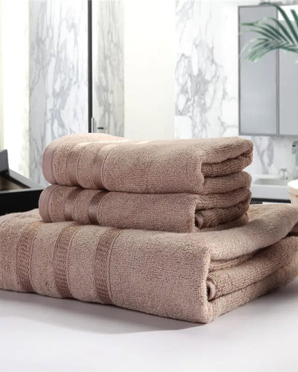 Stack of brown towels on a surface with a blurred indoor background
