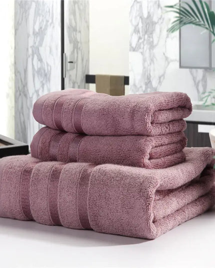 Stack of pink towels on a surface with a blurred indoor background