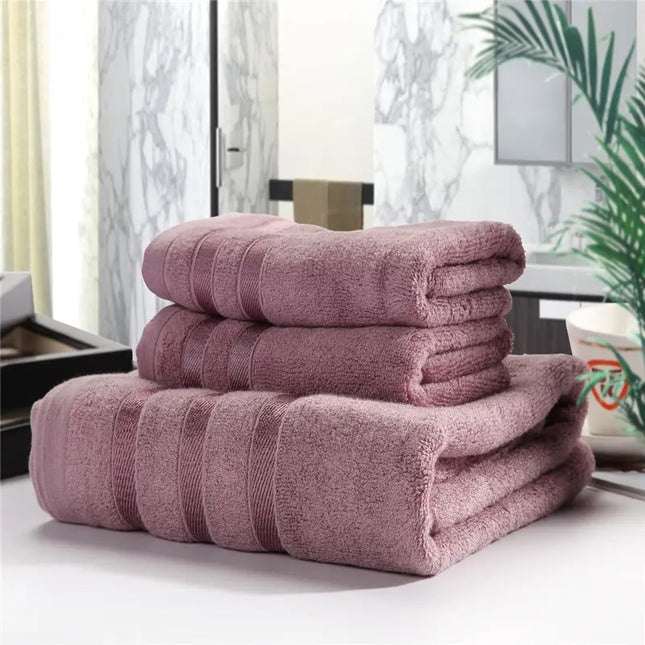Stack of pink towels on a surface with a blurred indoor background
