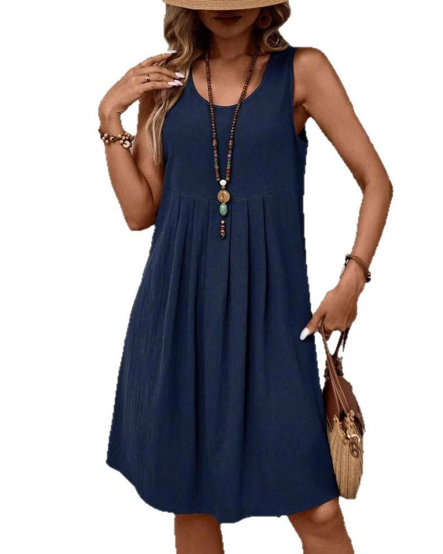 Woman wearing a navy blue sleeveless dress on a white background