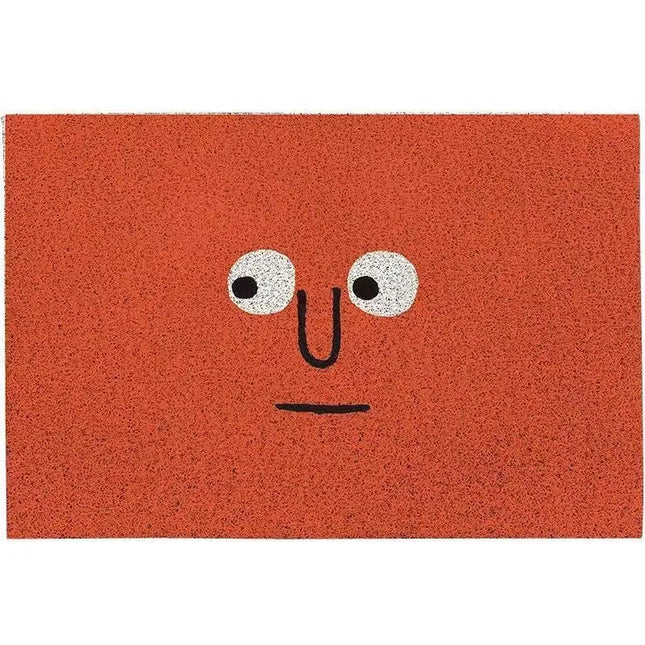 Orange doormat with a face design on a white background