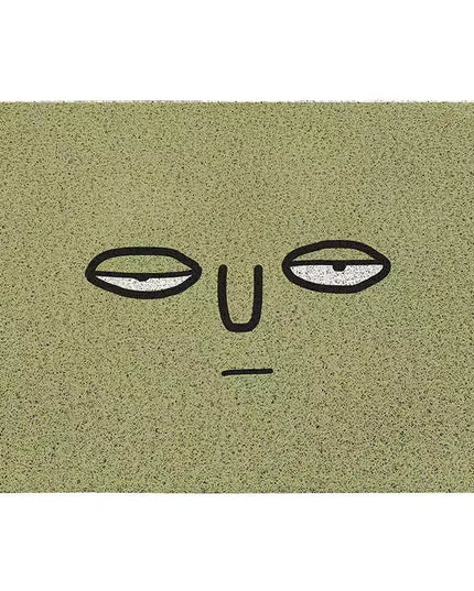 Doormat with a face design on a green background