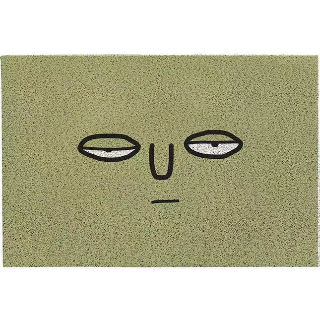 Doormat with a face design on a green background