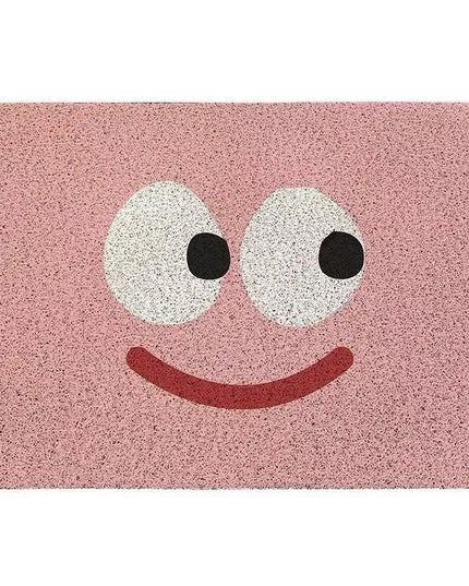 Pink doormat with a smiley face design on a white background