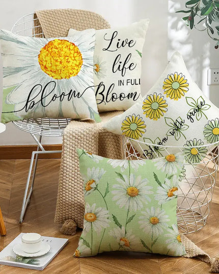 Decorative pillows with floral and motivational text on a wooden floor.