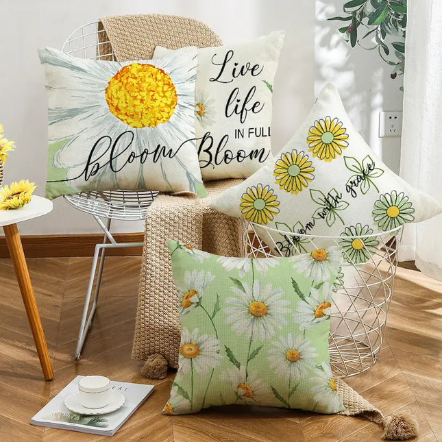 Decorative pillows with floral and motivational text on a wooden floor.