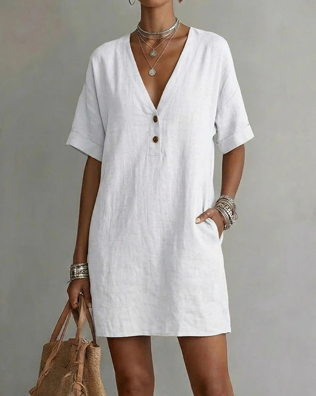 Woman wearing a white dress with a plain background