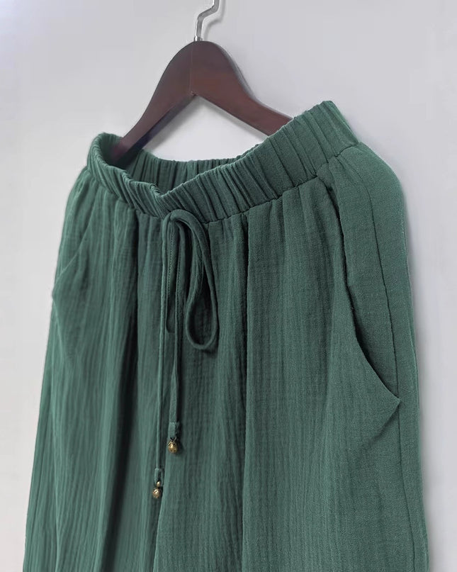 Green skirt on a hanger against a white background