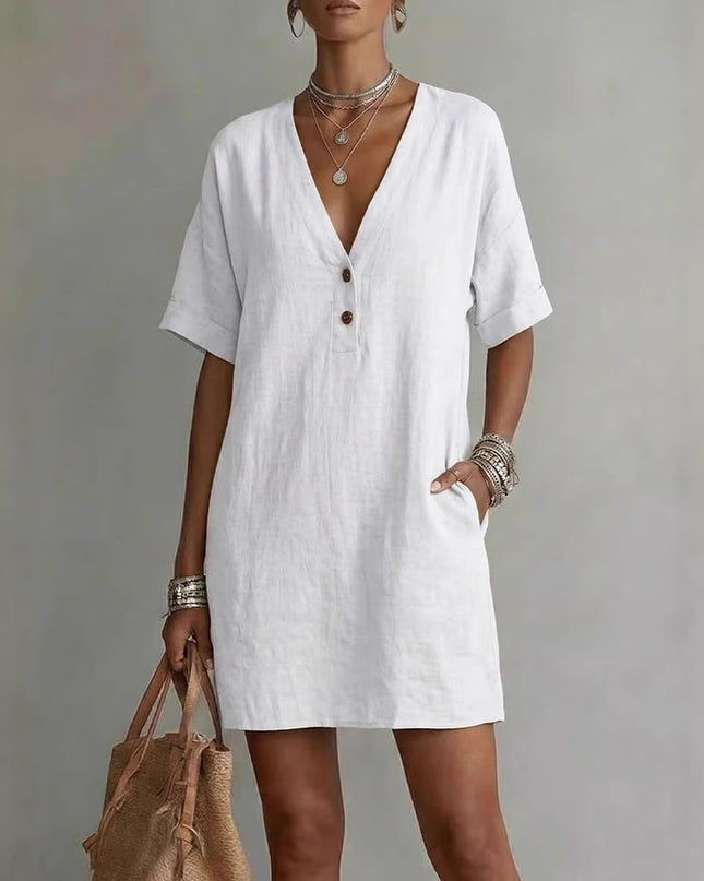 Woman wearing a white dress with a neutral background