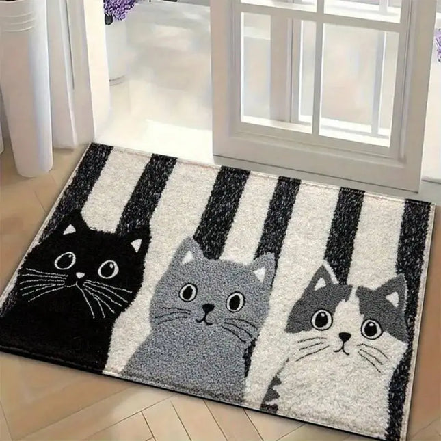 Decorative rug with cat designs on a wooden floor.
