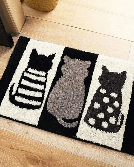 Doormat with cat designs on a wooden floor
