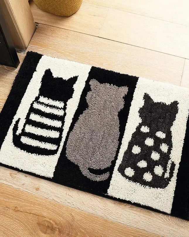 Doormat with cat designs on a wooden floor