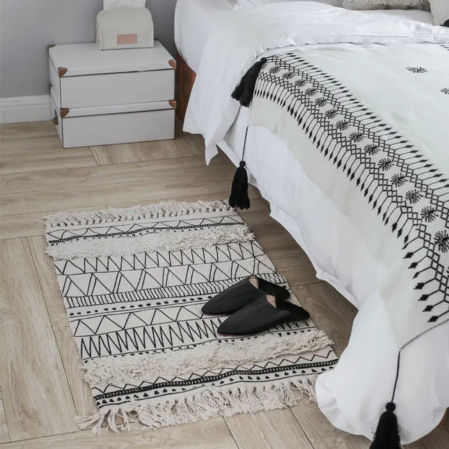 Bedroom with a patterned rug and white bedding