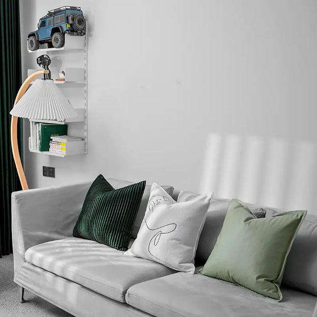 Gray sofa with decorative pillows in a living room setting.