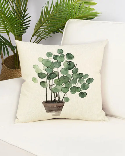 Decorative pillow with plant design on a white couch