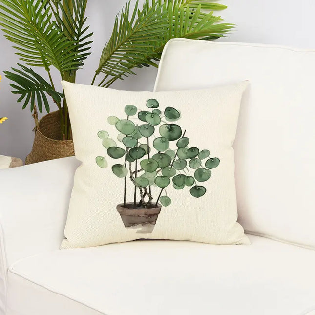 Decorative pillow with plant design on a white couch