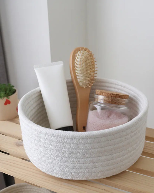 White woven basket with bathroom items on a wooden surface