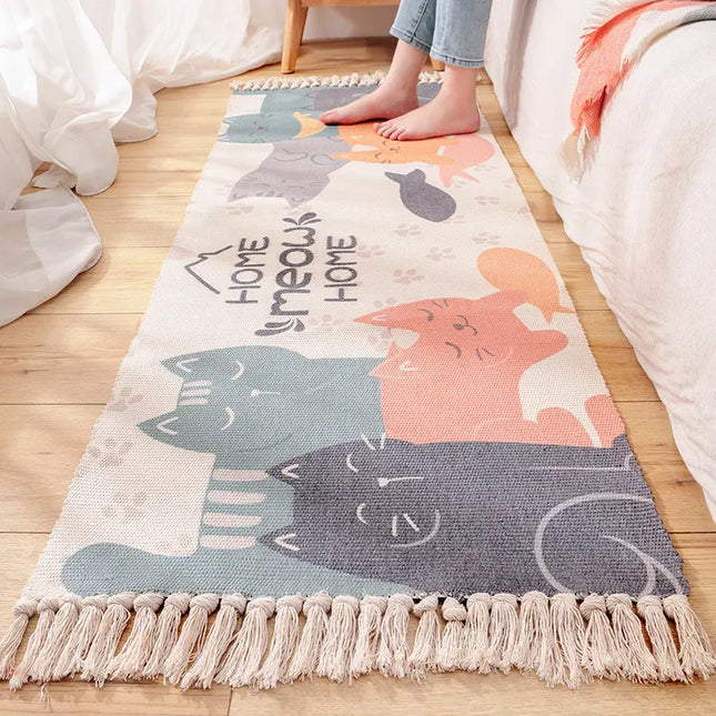 Colorful rug with cat designs and 'Homeomeow' text on a wooden floor.