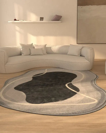 Modern living room with a curved sofa and abstract area rug.