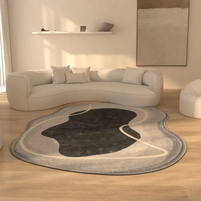 Modern living room with a curved sofa and abstract area rug.
